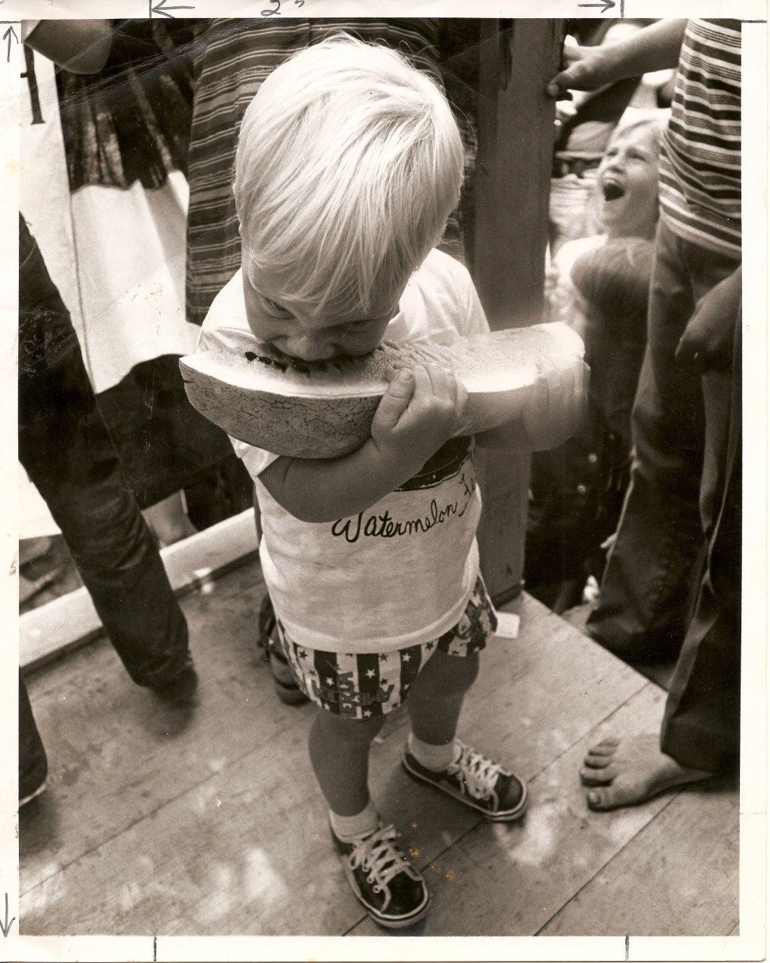 Little boy eating a large watermelon